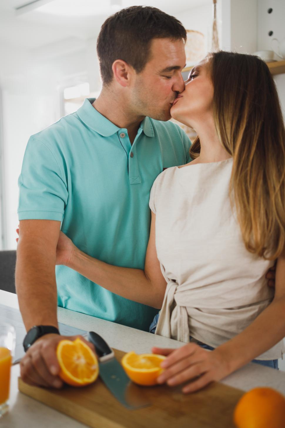 Free Image of Couple kissing in the kitchen 