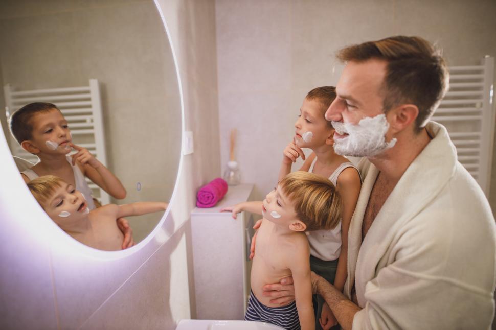 Free Image of Young father with kids shaving at home 