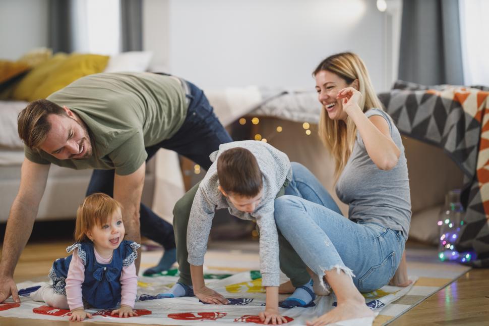 Free Image of Young parents playing with kids at home 