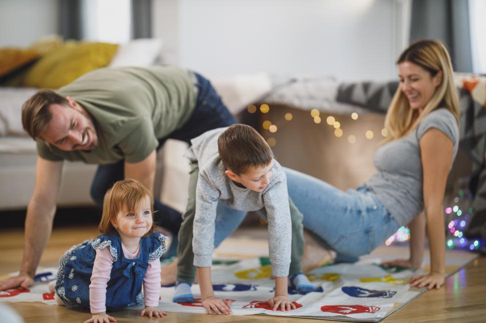 Download Free Stock Photo of Young parents playing with their kids at home 