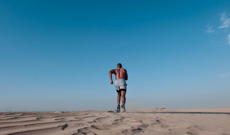 Free Image of Backside view of man running on the desert 