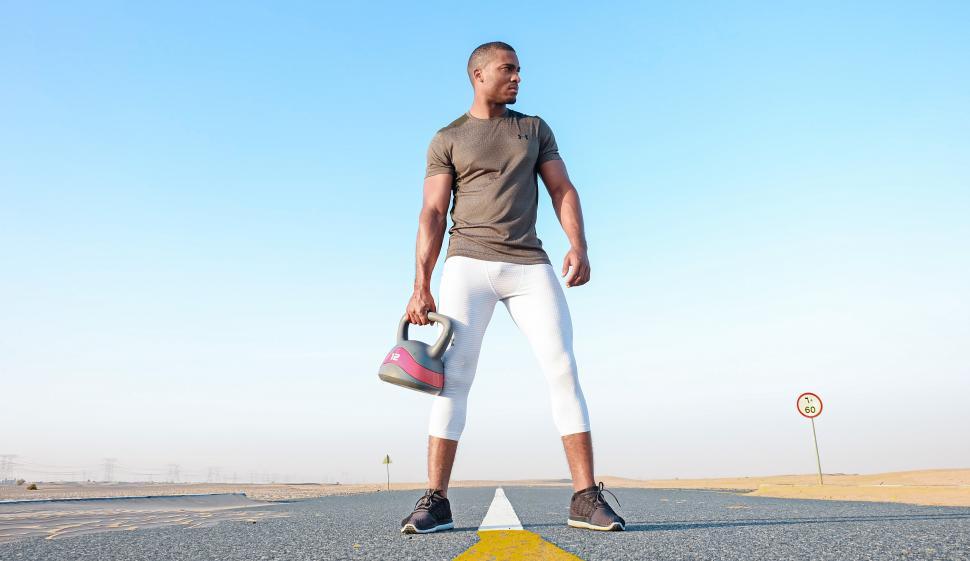 Free Image of Man with kettlebell on road - looking away 