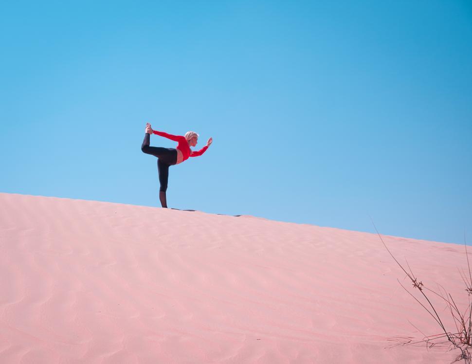 Free Image of Woman doing stretching on the desert 