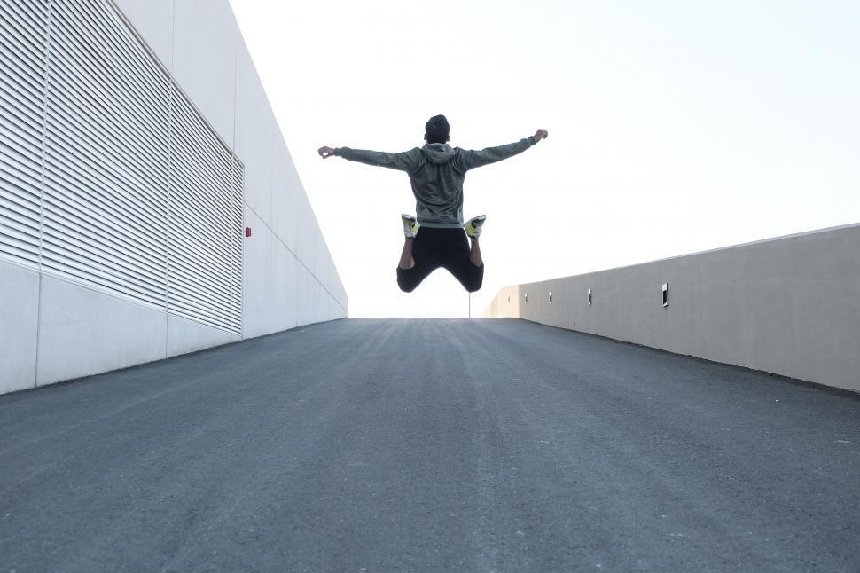 Free Image of Man jumping outside a building 
