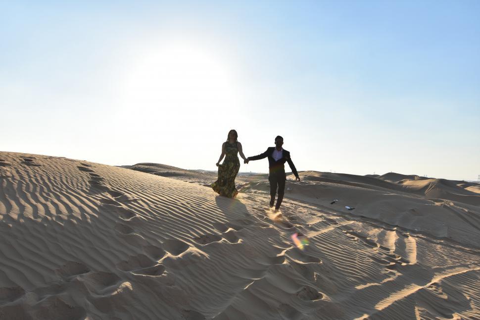Free Image of Couple walking in the desert 