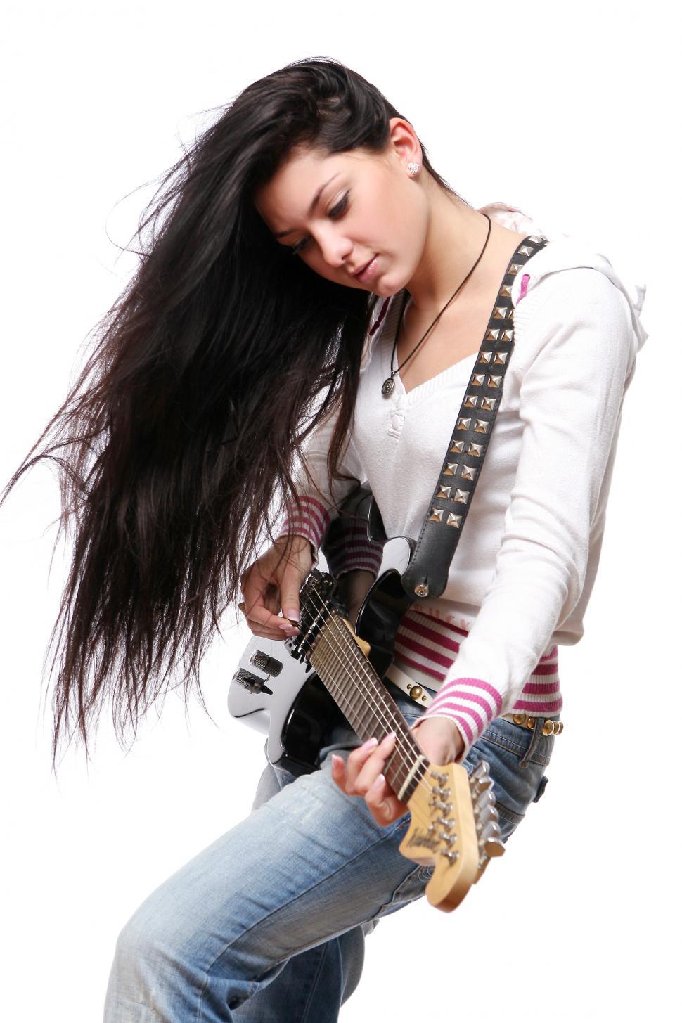 Free Image of Young woman playing electric guitar 