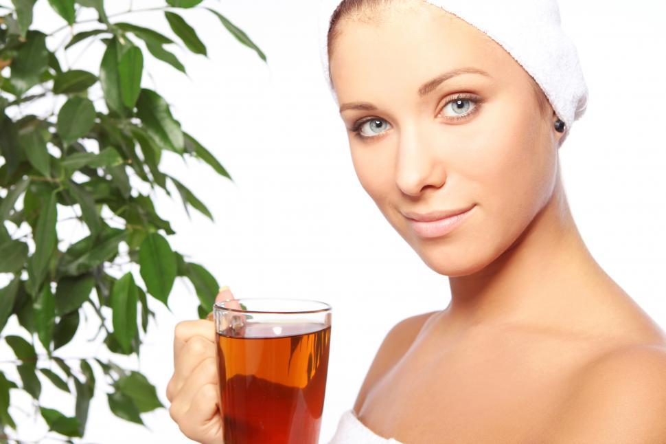 Free Image of Self care. Young woman with cup of hot tea and towel wrap 