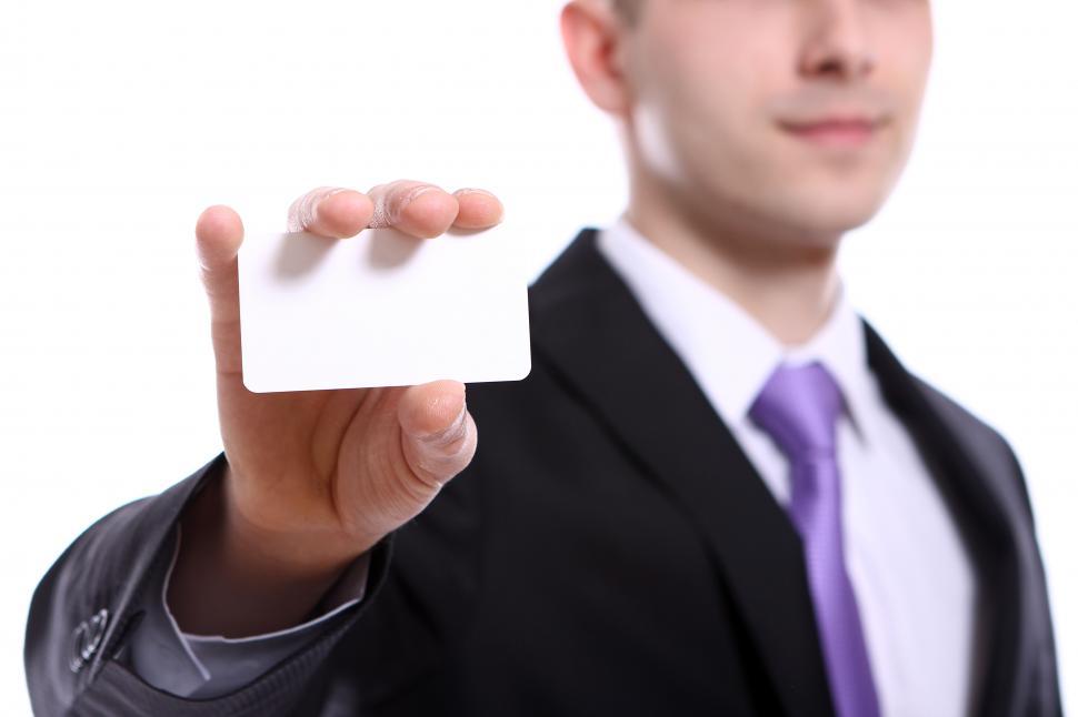 Free Image of Young businessman holding empty blank business card 