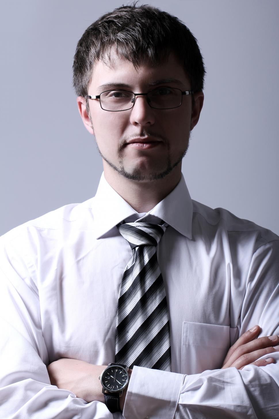 Free Image of Portrait of young businessman with crossed arms 