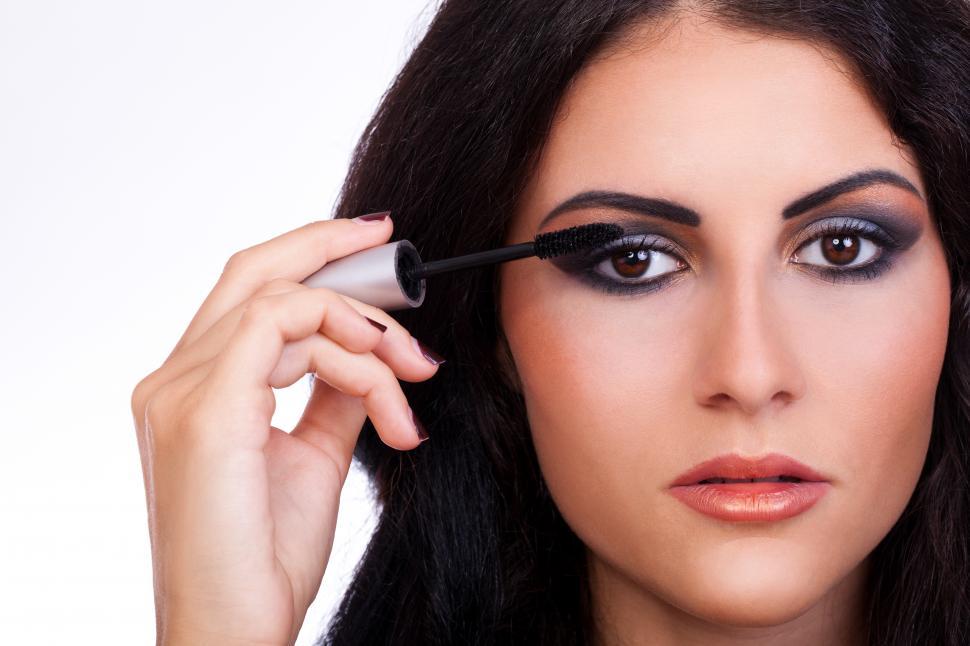 Free Image of Woman with mascara brush in hand 