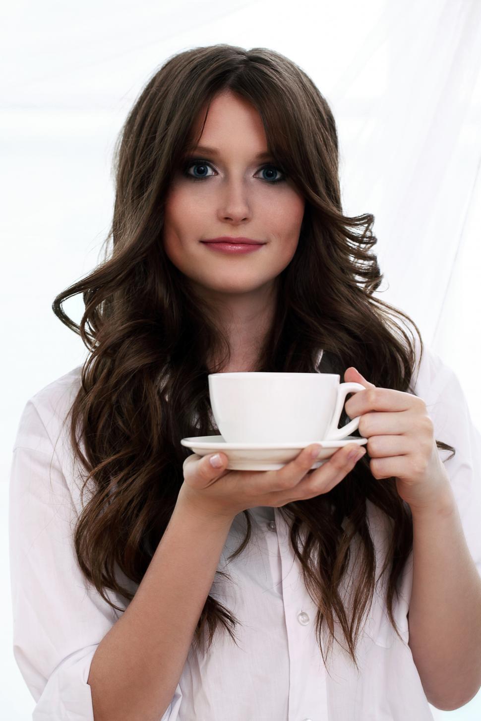 Free Image of Beautiful woman with cup of hot coffee against bright white background 