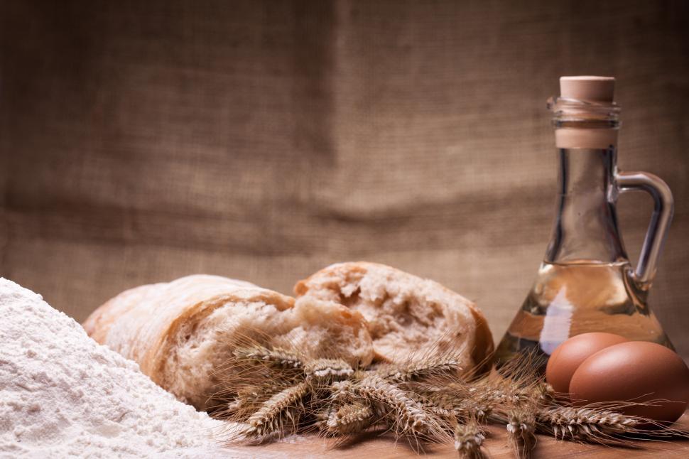 Free Image of Bread and baking ingredients on wooden table 
