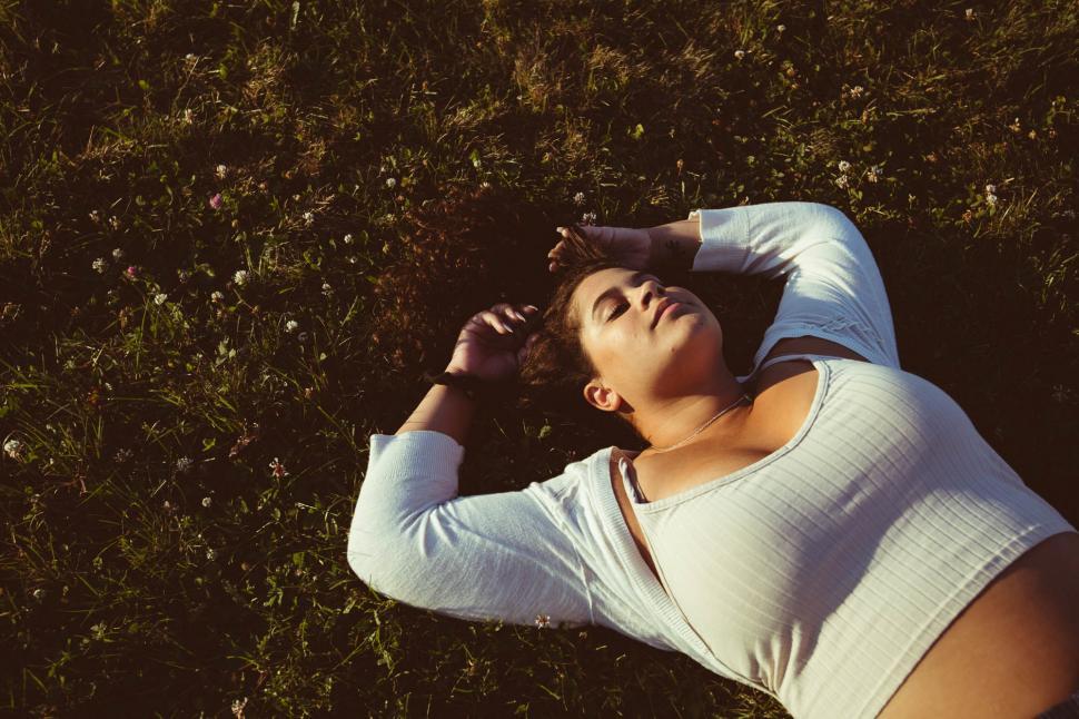 Free Image of Woman resting in the park - eyes closed 