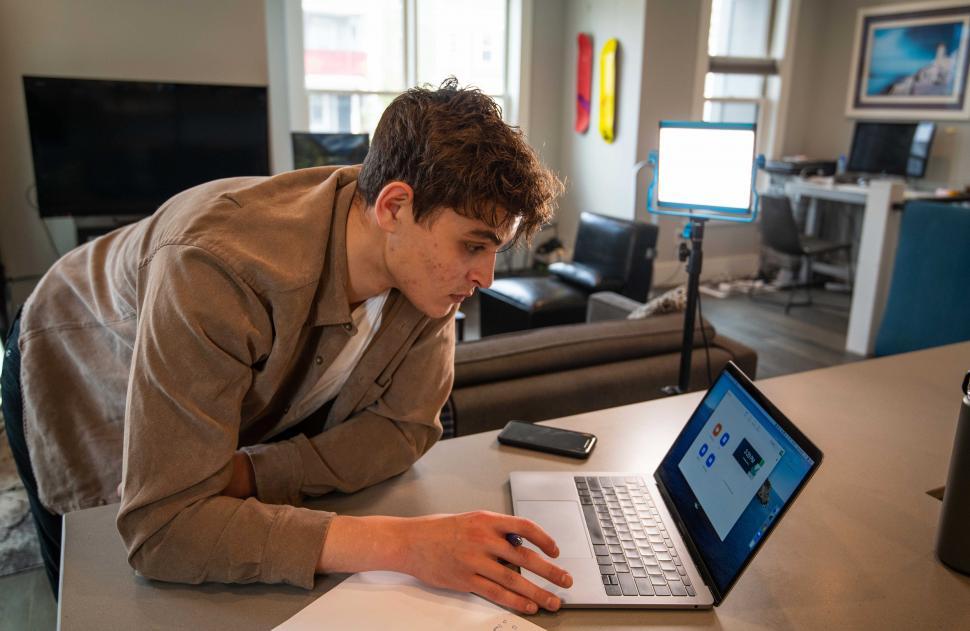 Free Image of Young man working with laptop at the office desk 