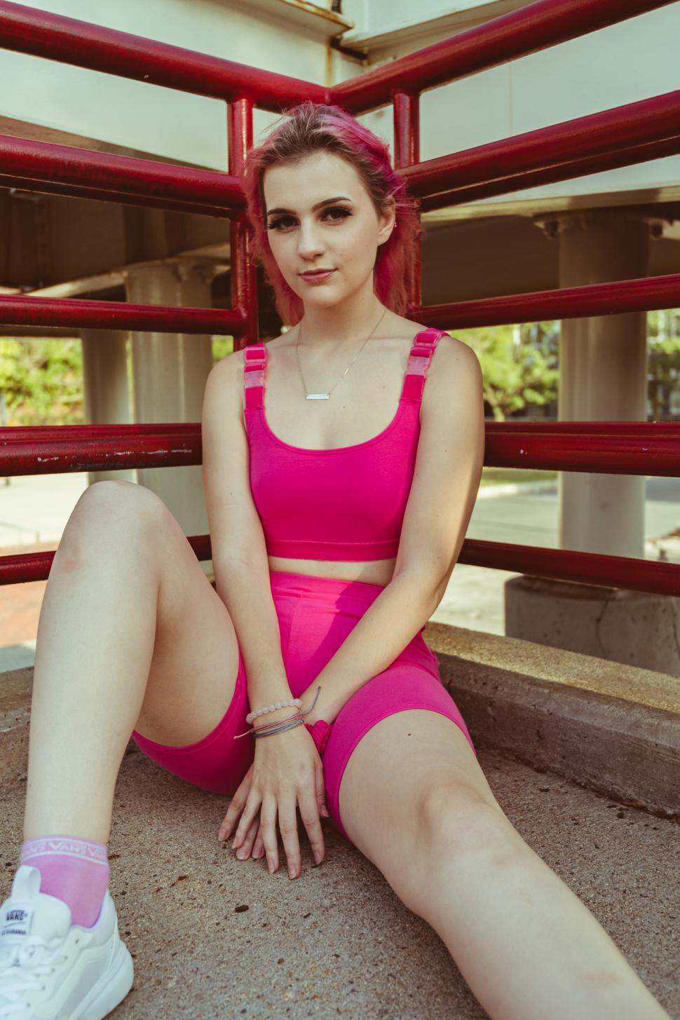 Free Image of Female fashion model wearing sports wear with pink hair - lookin 