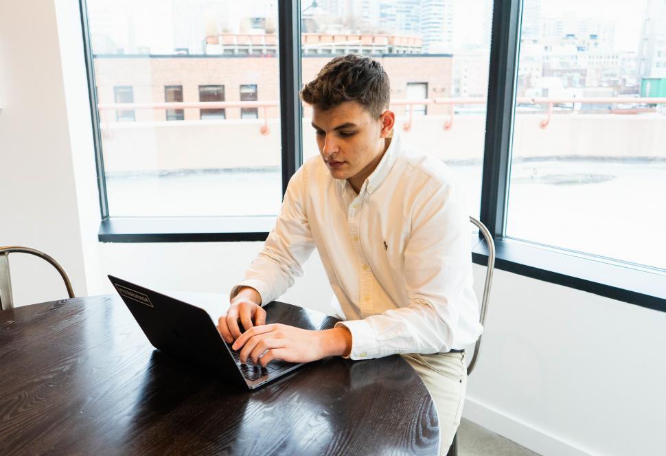 Free Image of Man working on laptop at the office desk 