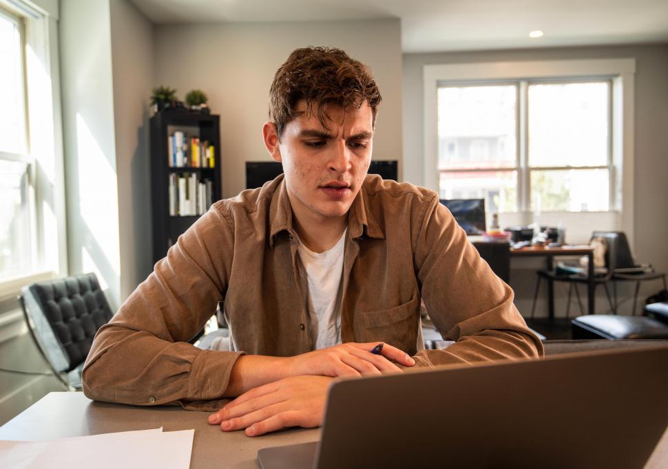 Free Image of Young man thinking with laptop 