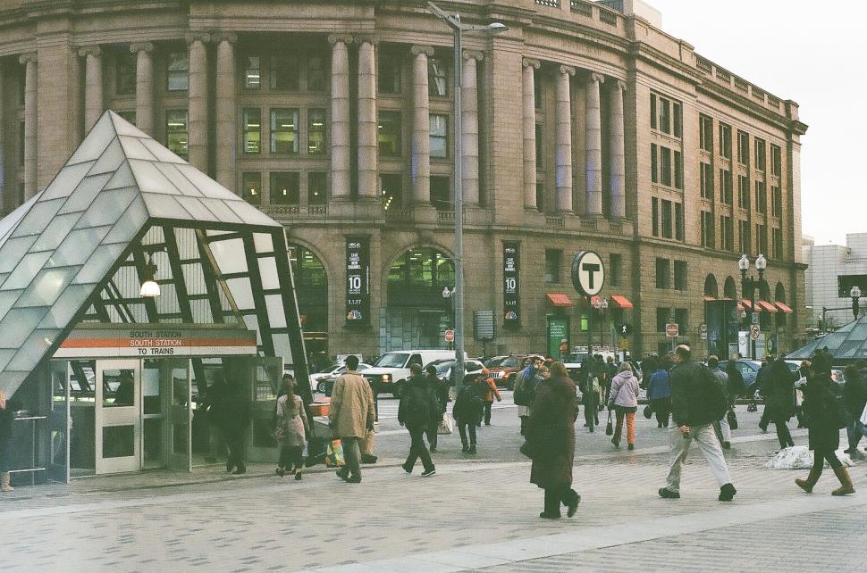 Free Image of People on the street in front of train station 