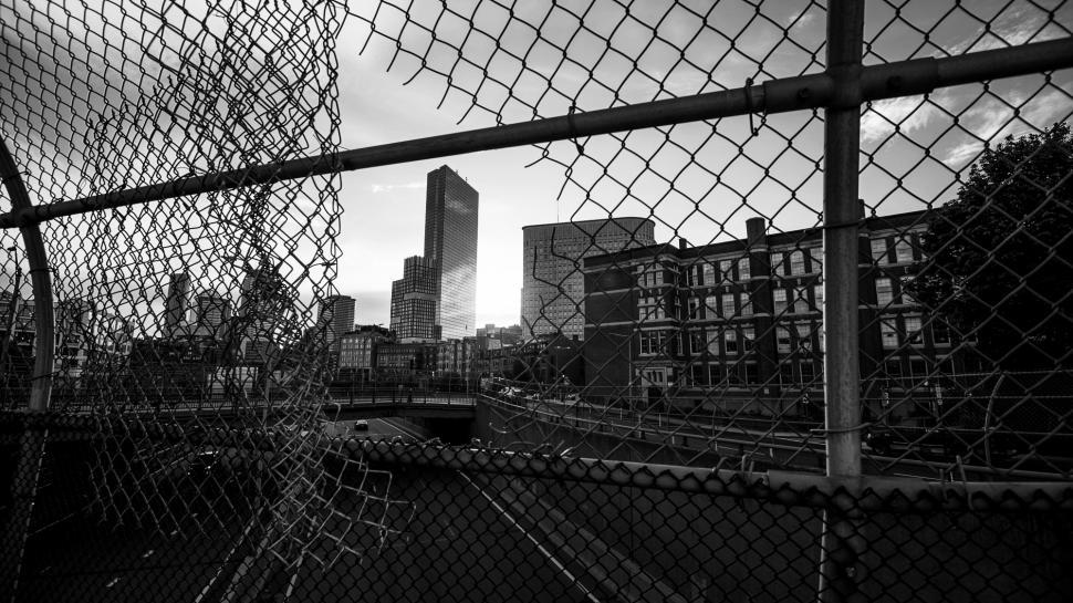 Free Image of Chain link fence with buildings - b&w 