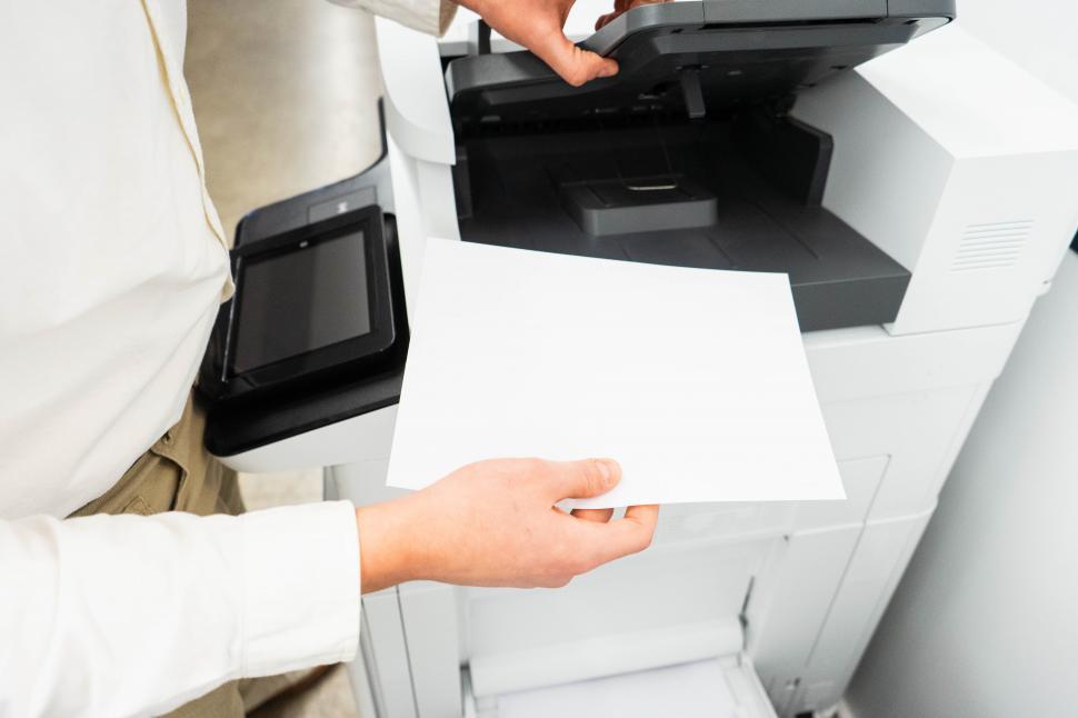 Free Image of Hands and paper with copy machine 