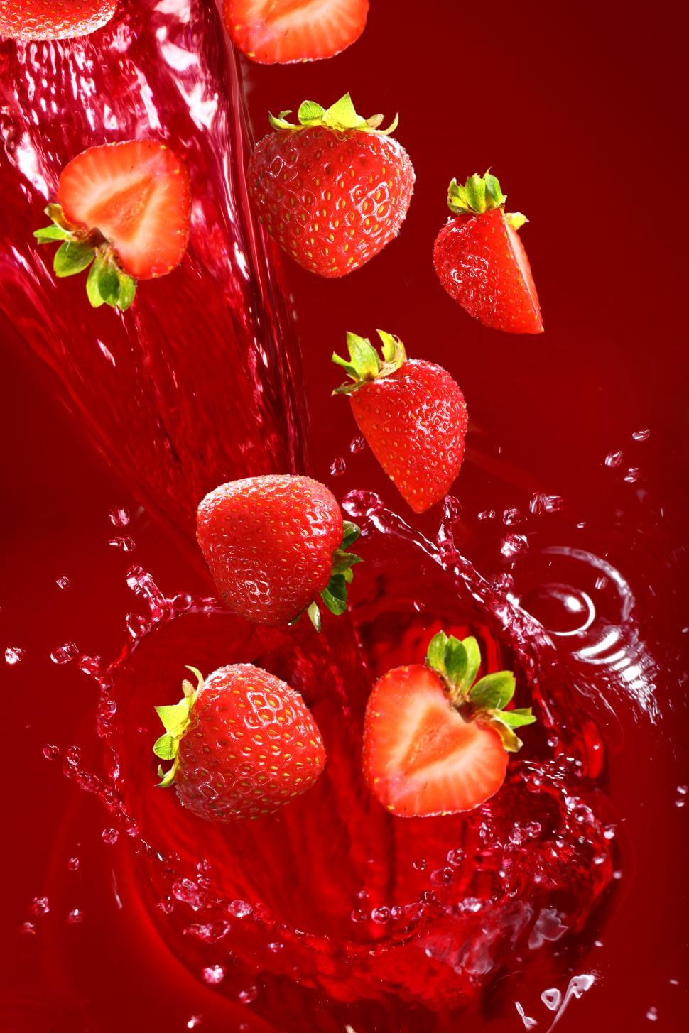 Free Image of Strawberries falling into cascade of juice 