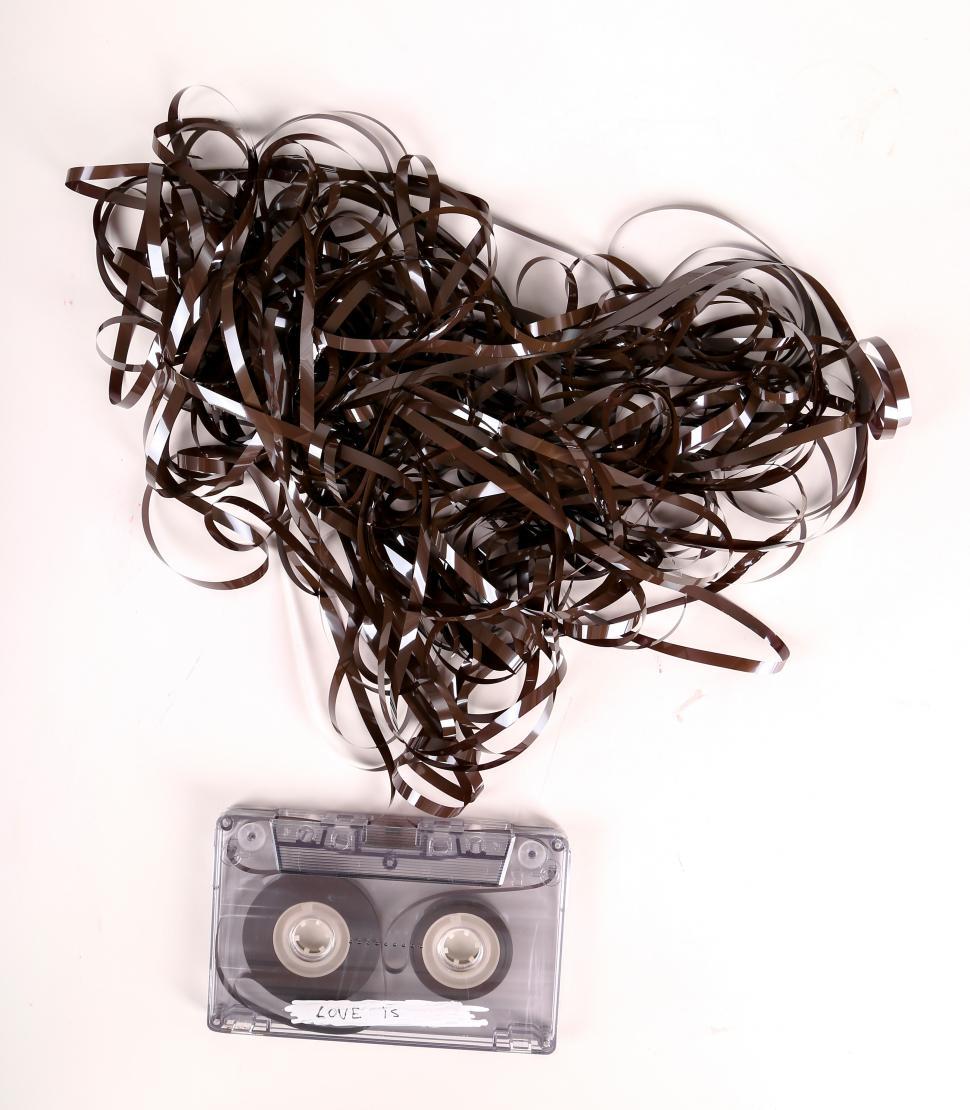 Free Image of Cassette tape with magnetic tape unspooled into a heart shape mass 