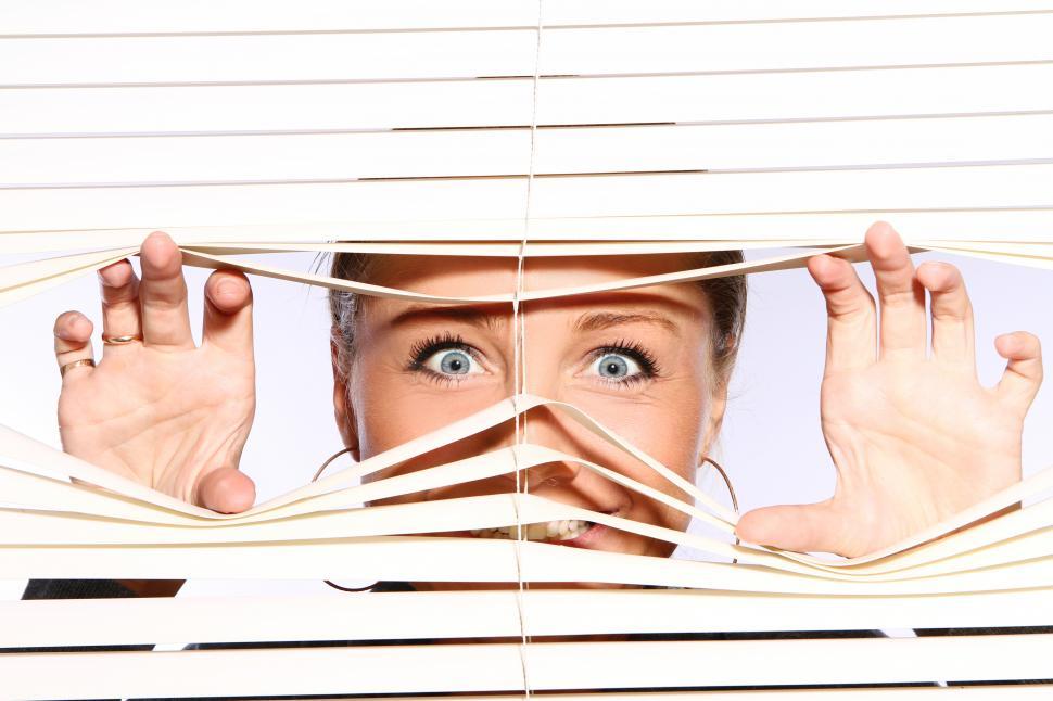 Download Free Stock Photo of Crazed woman looking out the window 