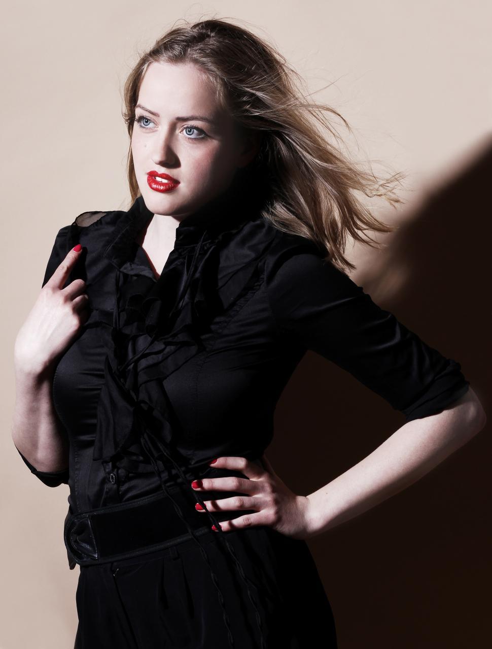 Free Image of Young woman wearing all black in studio 