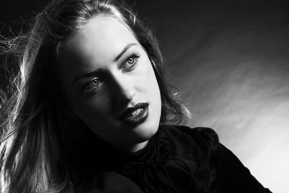 Free Image of Young woman in dark studio setting 