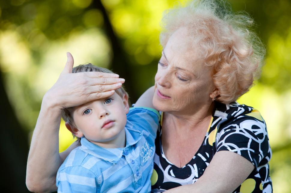 Free Image of Grandmother feeling the head of her grandson in the park 