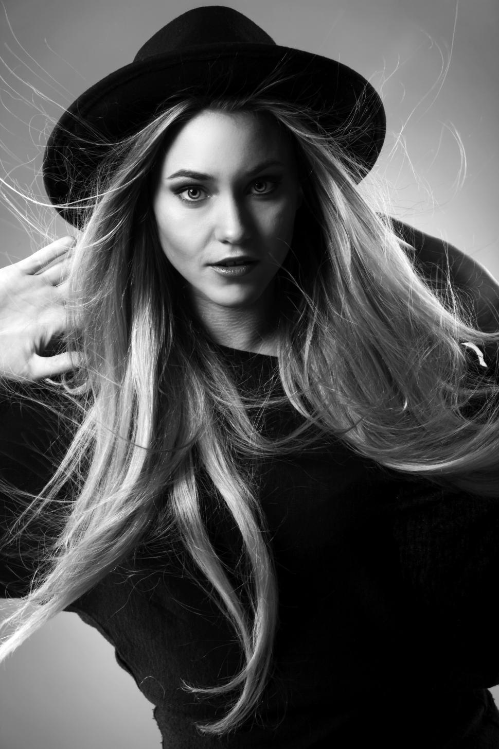 Free Image of Blonde woman in black with hat on her head 