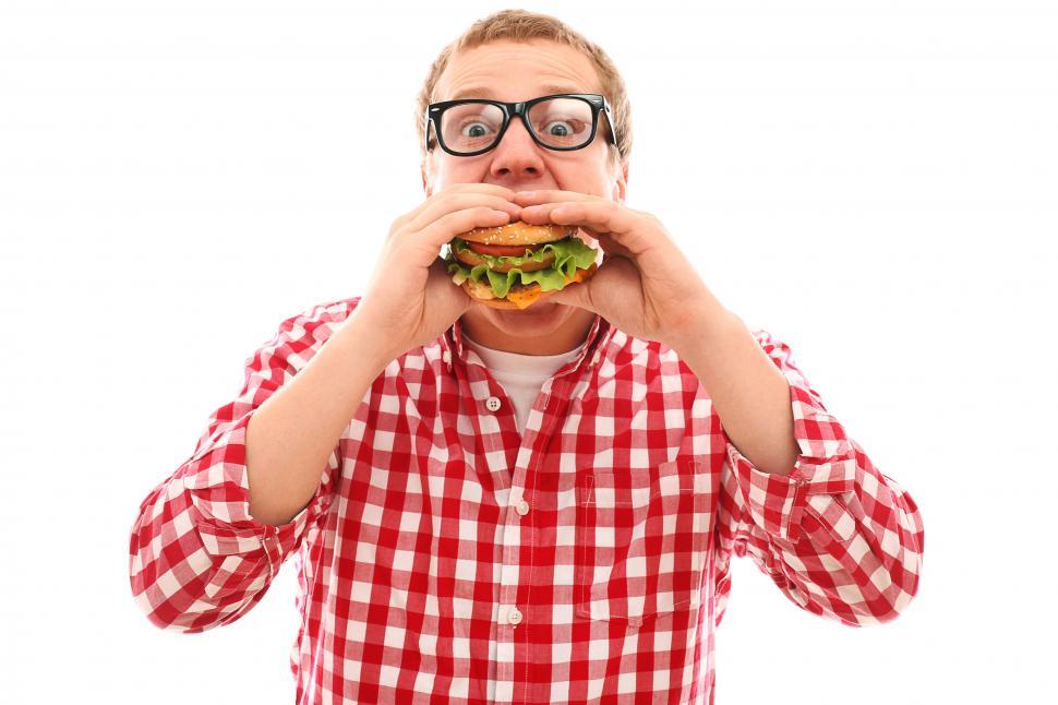 Download Free Stock Photo of Guy eating a burger, holding with both hands 