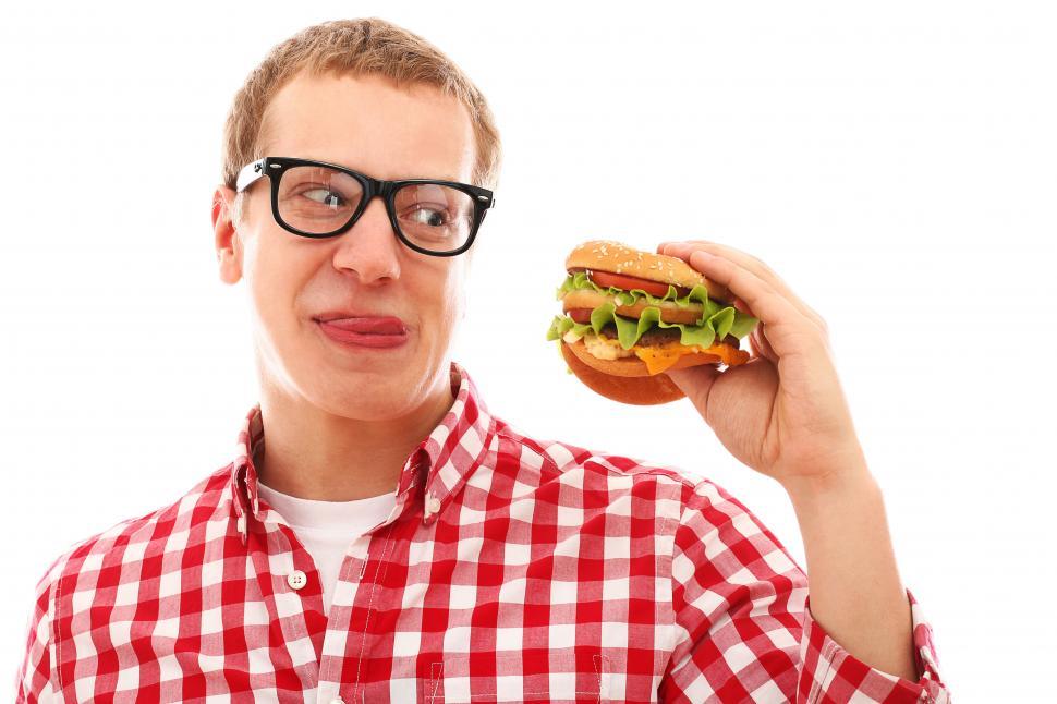 Free Image of Hungrily eyeing a big hamburger 