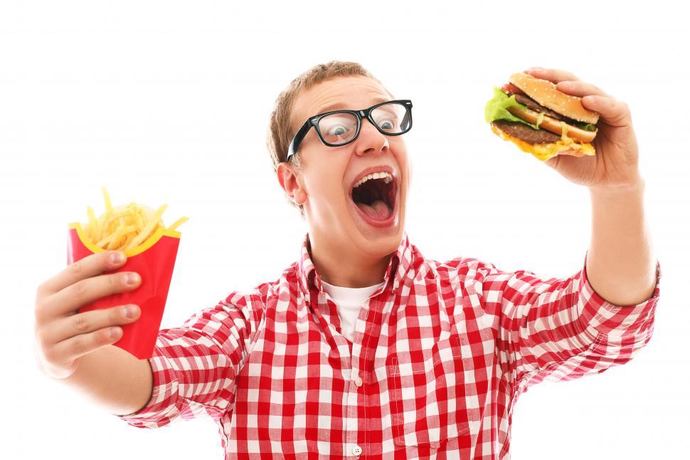 Free Image of Guy is super excited about a hamburger and french fries 