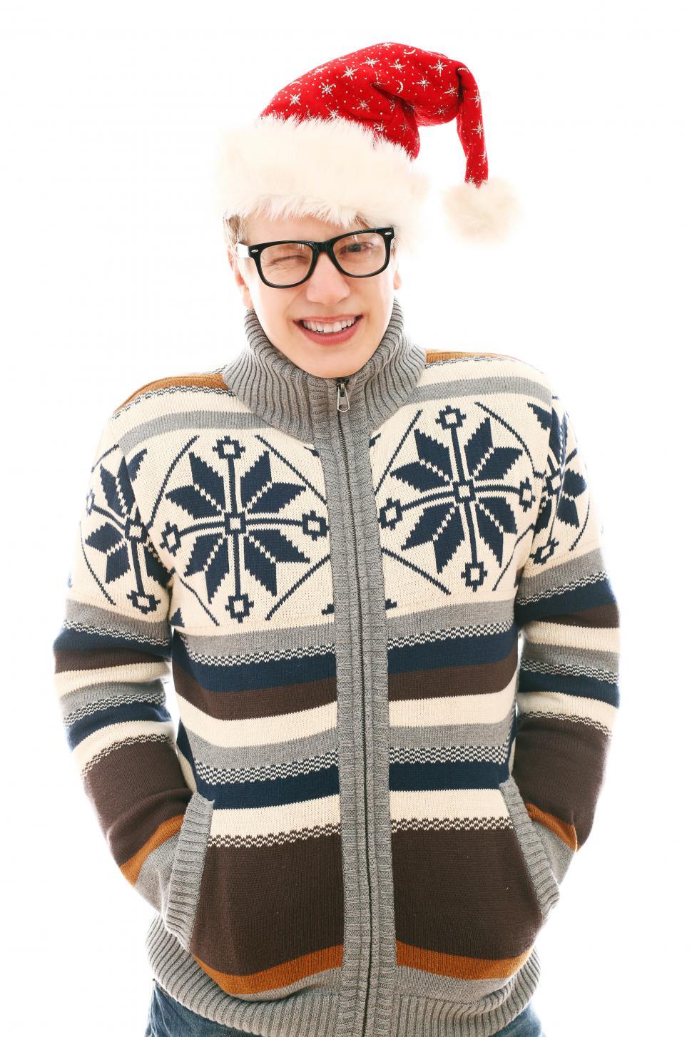 Free Image of Young guy in a sweater and a Santa hat 