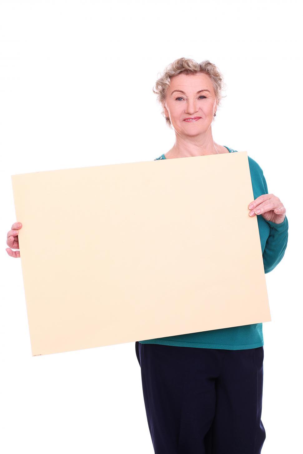 Free Image of Mature woman holding a blank sign - add your text or message 