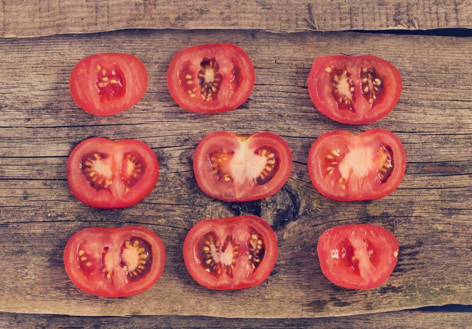 Free Image of Red tomato slices laid out - one tomato sliced 