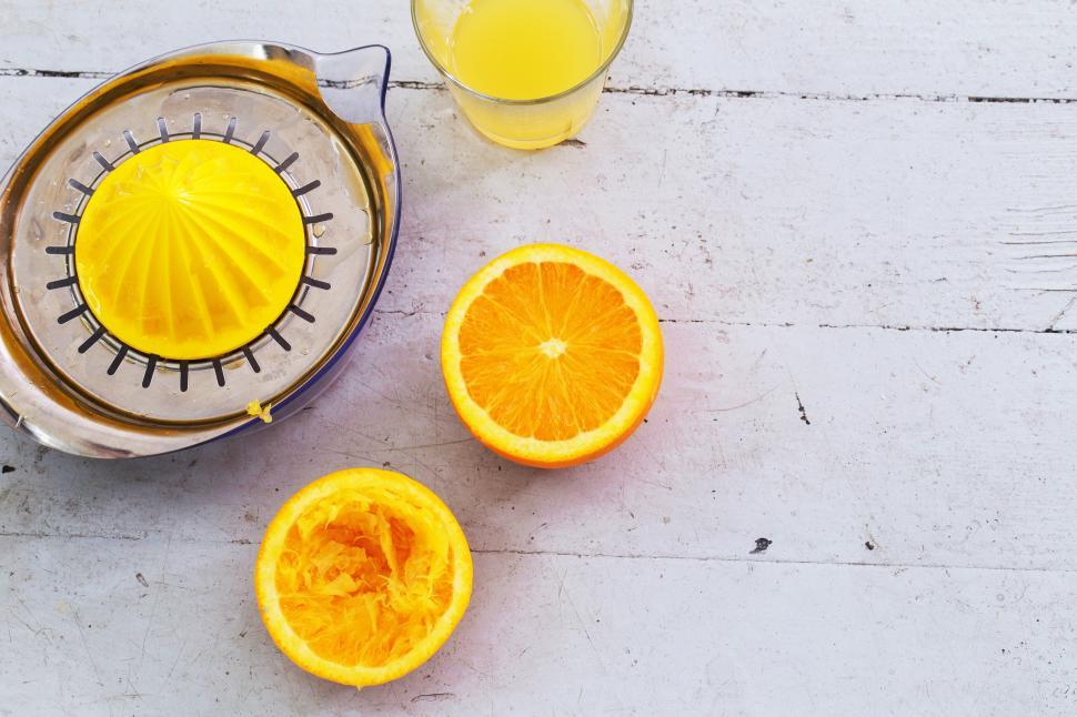Free Image of Oranges, juice and juicer on a table 
