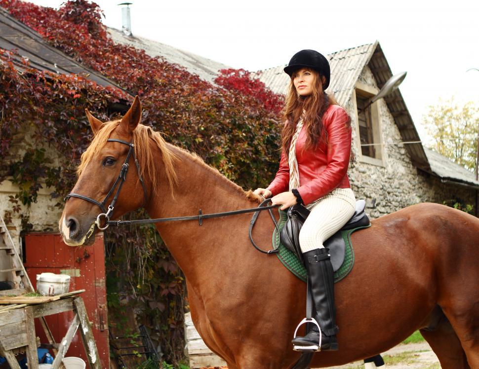 Free Image of Rider on a horse in semi-formal setting 