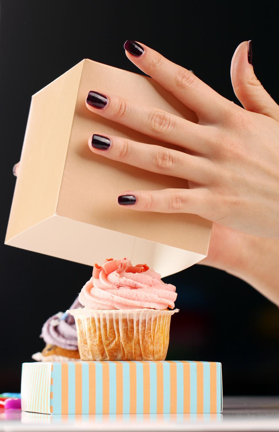 Free Image of Hands reveal a celebratory cupcake 