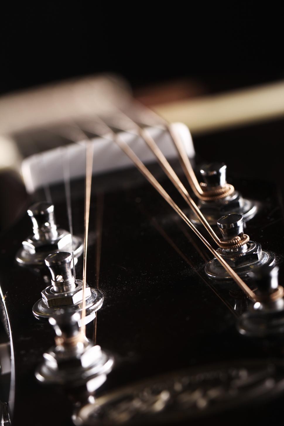 Free Image of Head of a classic acoustic guitar, tuning pegs 