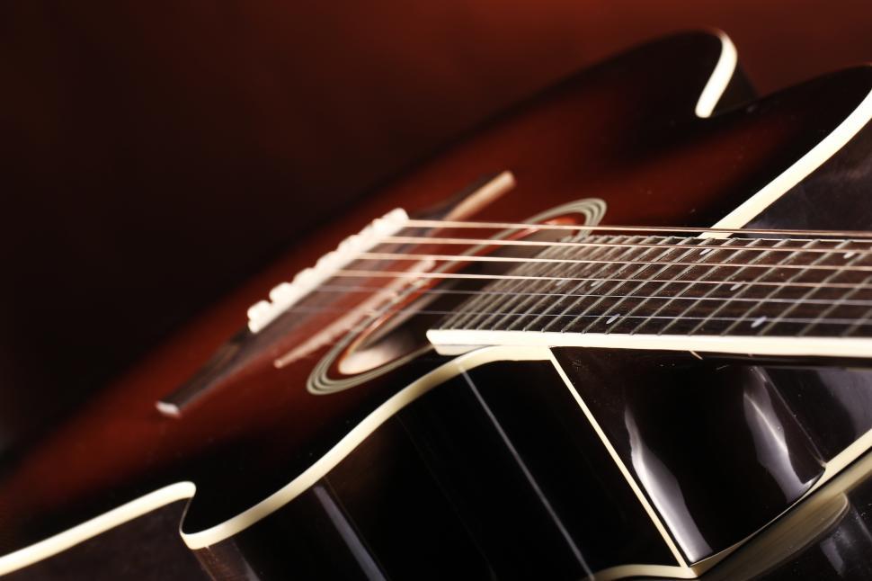 Free Image of Strings of an acoustic guitar, angled view 