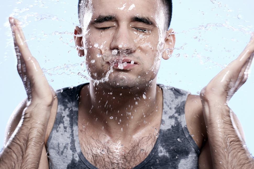 Free Image of Guy washing his face, splashing water 