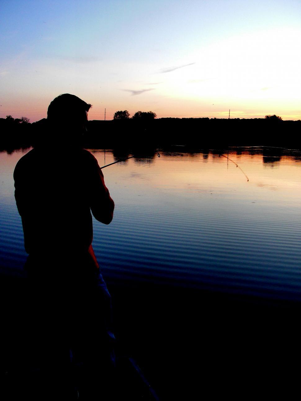 Free Image of Man Standing Next to Body of Water 