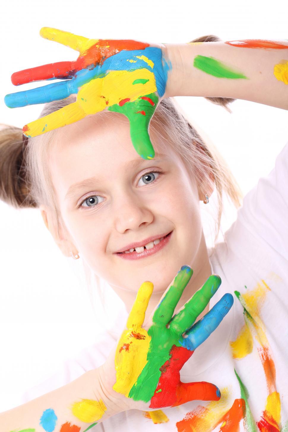 Free Image of Happy girl with paint on her hands 