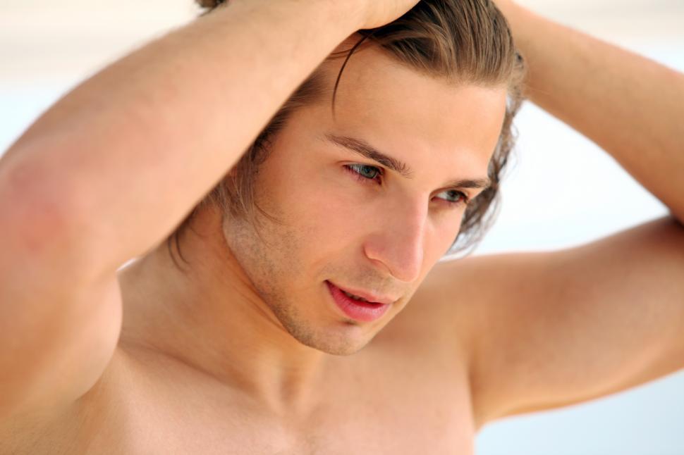 Free Image of Close up of young and handsome guy on the beach 