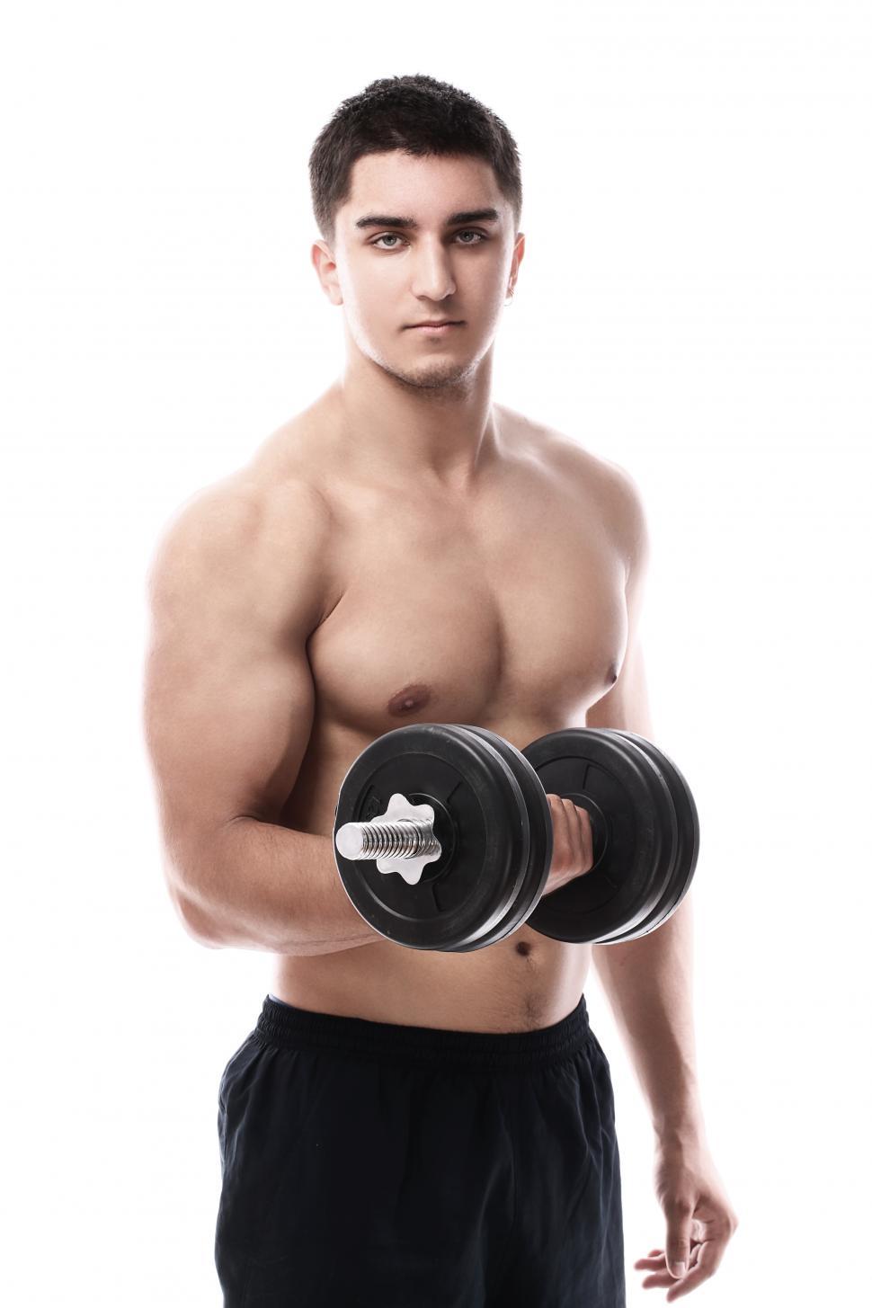 Free Image of Muscular guy working out with dumbbell 