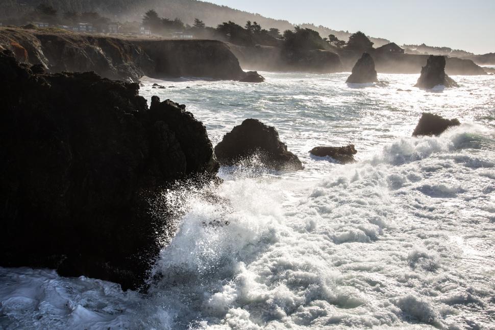 Free Image of Rough waves crash on the rocky coast 