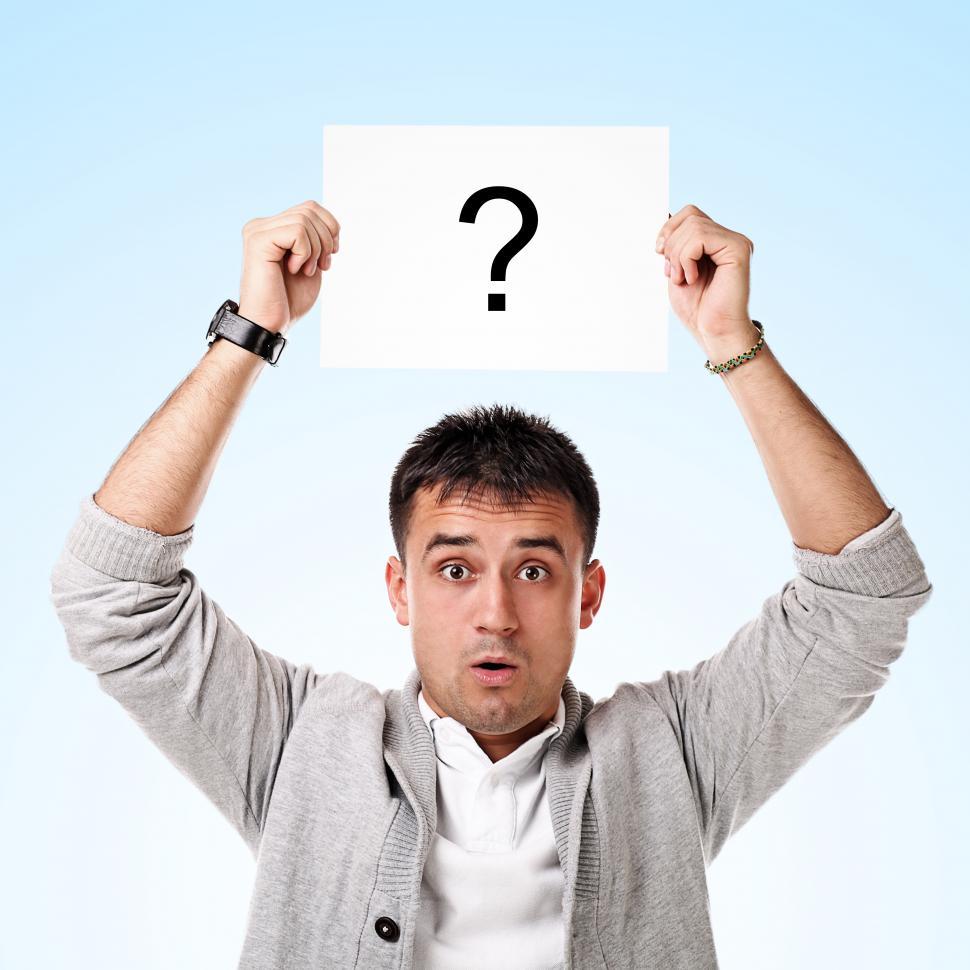 Free Image of Man is puzzled and holding up a card with a question mark 