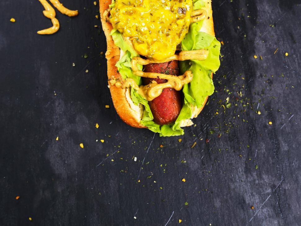 Download Free Stock Photo of One end of a hot dog, lots of mustard 